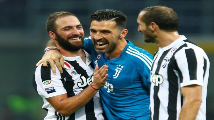 Gonzalo Higuaín celebrates Saturday's win at Milan with Gigi Buffon and Giorgio Chiellini