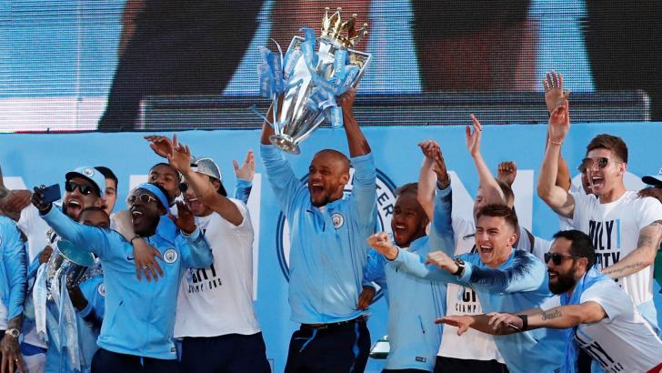 Man City players celebrate winning the Premier League.