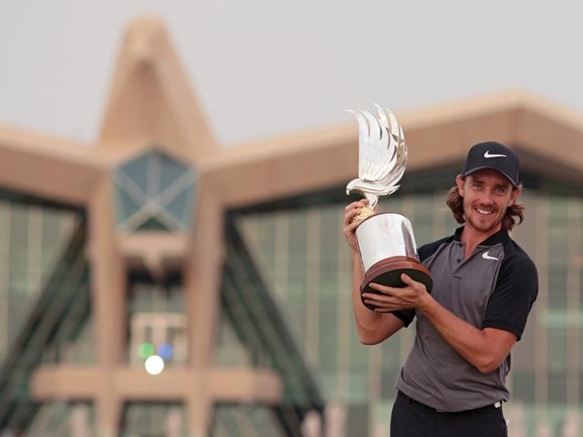 Tommy Fleetwood holds aloft the Abu Dhabi trophy