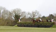 Runners jumping a bank fence at Punchestown.