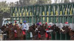 Horses break from the stalls