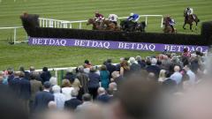 Punchestown runners jumping a fence.